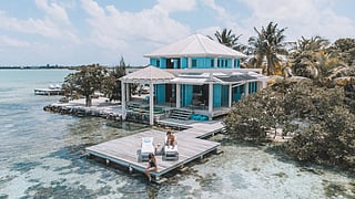 Aerial view of Cayo Espanto resort villa surrounded by turquoise water