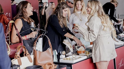 Attendees browse handbags and jewelry at the Pitch to LAFS showcase
