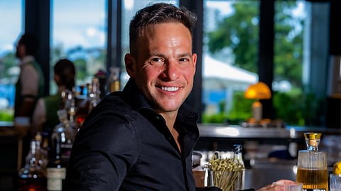 Jayson Winer sitting at a bar with a Casa MALKA drink