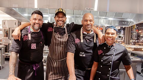 Chefs posing together in the kitchen at the Antigua and Barbuda event