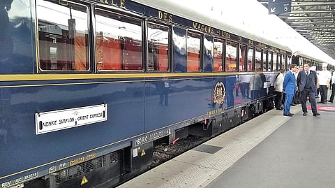 Vintage blue Orient Express train at a station platform