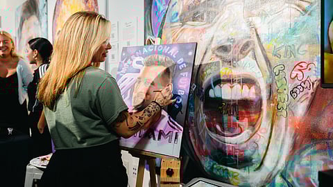 Artist creating a portrait during a Wynwood art event