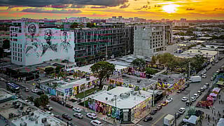 Aerial view of Wynwood at sunset showing murals, restaurants, and city streets during the holidays