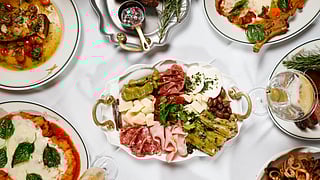 Overhead view of Italian dishes and antipasti served at Anthony’s Runway 84 during the holidays