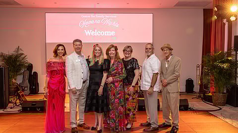 Center for Family Services board members standing on stage at the Havana Nights fundraiser