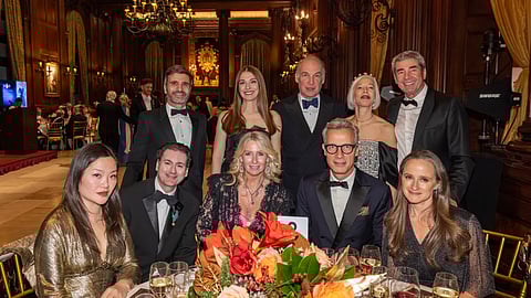 Black-tie guests seated at a formal table during the Royal Savoy Ball in New York City