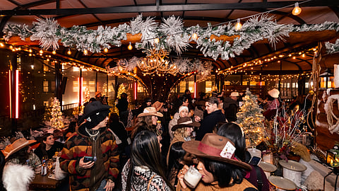 Crowded Magic Hour Mountain Lodge winter pop-up on NYC rooftop with alpine décor and cocktails