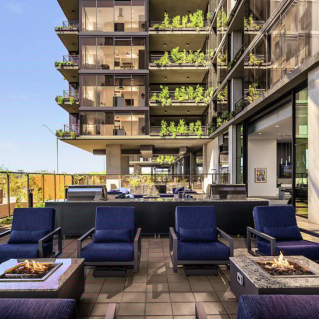 Outdoor amenity terrace with fire pits, seating, and biophilic balconies at Optima McDowell Mountain