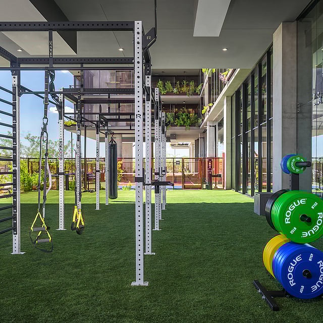 Fitness center with turf and equipment at Optima McDowell Mountain