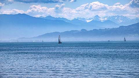 Sailboats on Lake Constance with alpine mountains in the distance near Buff Medical Resort