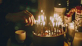 Birthday cake with lit candles on a table during an intimate evening celebration