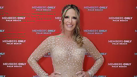 Woman in a gold embellished gown at Members Only Palm Beach event