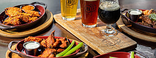 Craft beer flight and wings at Batch Gastropub Miami, a popular Brickell spot for game-day viewing
