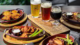 Craft beer flight and wings at Batch Gastropub Miami, a popular Brickell spot for game-day viewing