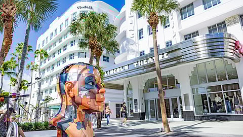 Large mirrored head sculpture by Oscar Esteban Martinez installed on Lincoln Road in Miami Beach