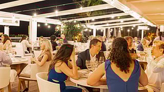 Guests dining outdoors at Eden Roc Miami Beach during the South Beach Wine & Food Festival