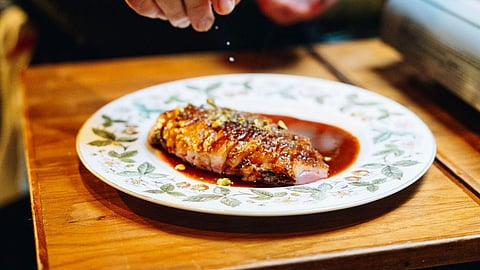 Duck dish plated tableside at Michelin-starred Ariete restaurant in Miami