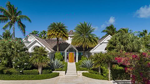 Front of Salacia Villa on Grace Bay featuring tropical landscaping and a coastal-style residence