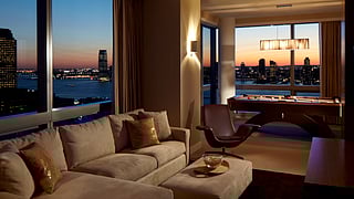 The Dominick's Tribeca Penthouse living area overlooking the city in the evening