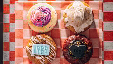 Assorted decorated cookies from Cry Baby Creamery arranged on a red checkered surface