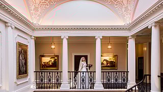 Bride in an elegant Regency-style hall at The Langley hotel in Buckinghamshire, UK