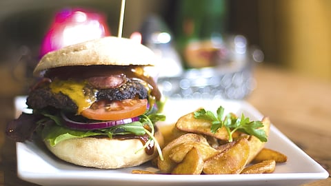 Bacon cheeseburger with fries served at Union Burger Bar in Southampton, New York