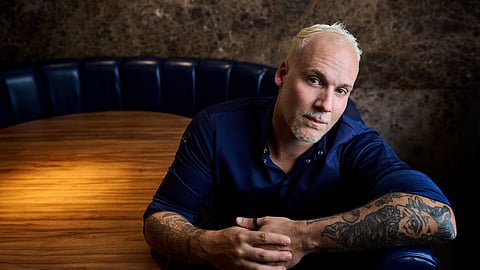 Chef seated at the omakase counter inside MILA Omakase in Miami