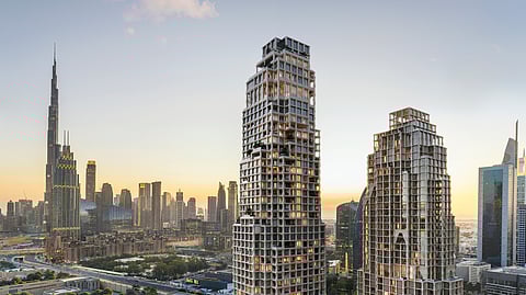Janu Dubai mixed-use tower in DIFC with Burj Khalifa skyline at sunset