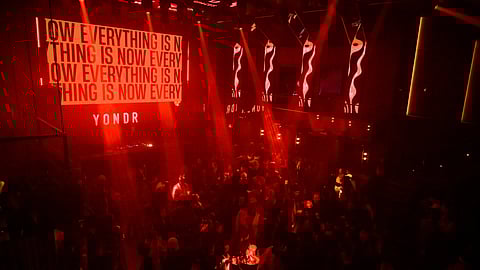 Crowd under red lights at Marquee for Public School phone-free NYFW event