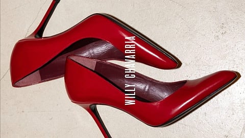 Red leather stiletto pumps from Willy Chavarria collaboration displayed on neutral surface
