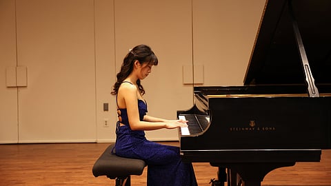 Tina Wang in blue gown performing at her Master’s Solo Recital at CSUN