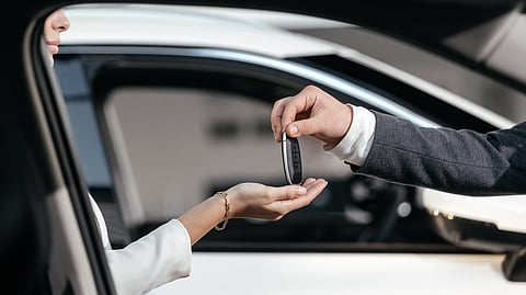 Close-up of luxury car key exchange for Dubai VIP car rental service