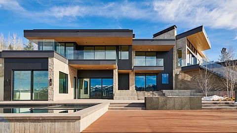 Modern Aspen estate exterior with pool, glass balconies, and mountain views in Starwood