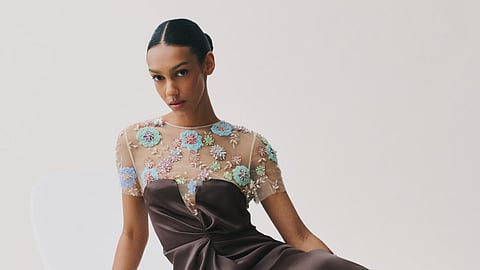 Model reclining in brown satin gown from Ninfee FW 2026 collection