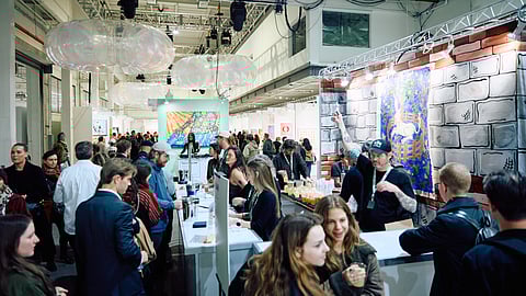 Crowds gather at the bar inside The Other Art Fair at the Brooklyn Navy Yard