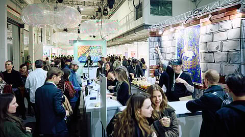 Crowds gather at the bar inside The Other Art Fair at the Brooklyn Navy Yard