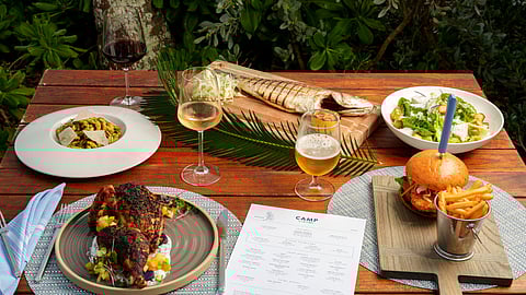 Assorted CAMP dishes and drinks served outdoors at The Loren Turtle Cove