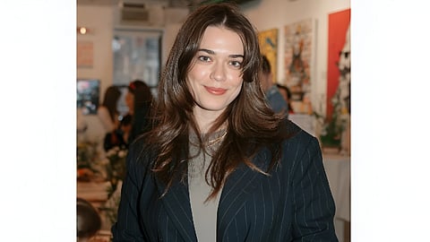 Kateryna Shutko holding a professional camera at a New York fashion photography event