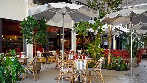 Outdoor patio dining at Michael’s Genuine in Miami Design District with shaded tables and greenery