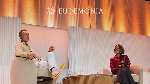 Speakers in conversation on stage during the Eudēmonia Summit wellness conference