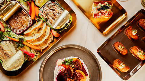 Overhead view of conservas, tapas, and caviar plates served at Seirēn NYC