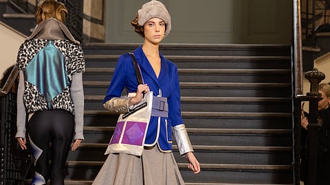 Model wearing blue jacket and full skirt on Francesca Liberatore runway