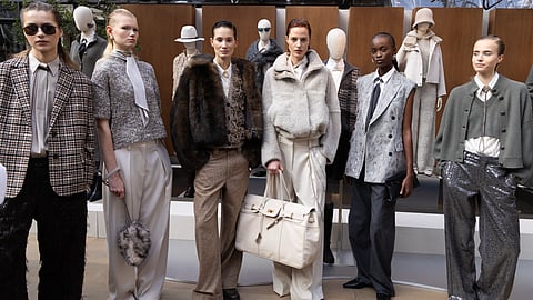 Models wearing Brunello Cucinelli fall winter 2026 tailored and knit looks at presentation