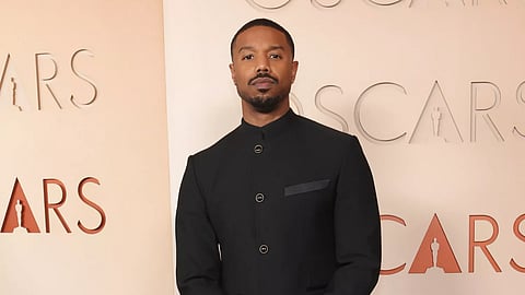 Michael B. Jordan wearing a black Louis Vuitton tuxedo on the Oscars red carpet