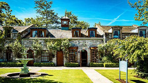 Stone courtyard with fountain and ivy-covered facade at the Village at Lyons in County Kildare