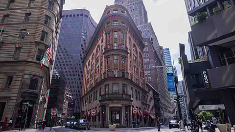 Interior of Delmonico’s main dining room with mural and white tablecloth seating