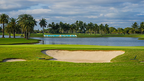 Golf green with bunker, lake and Trump Doral sign in Miami