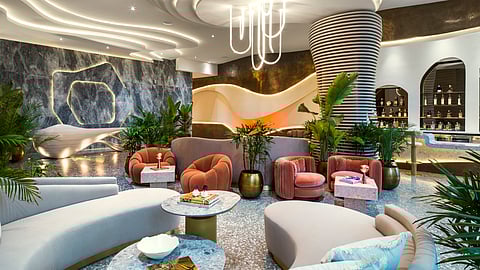 Curved seating, marble finishes and statement lighting define a modern Miami Beach hotel lobby