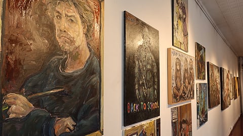 Gallery wall featuring multiple Chuck Connelly paintings in a Tribeca exhibition space