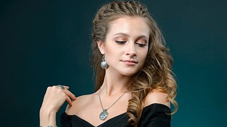 Woman wearing elegant silver jewelry designed for versatile day-to-night styling